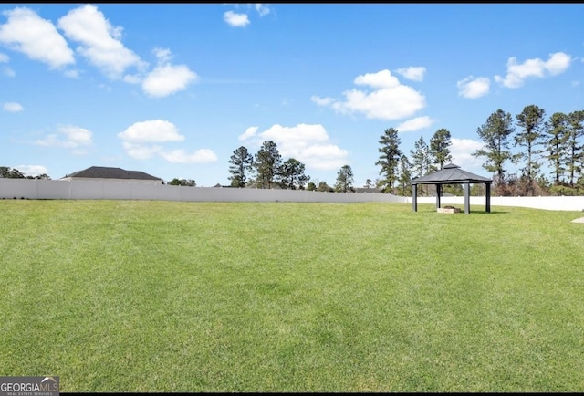 view of yard featuring fence and a gazebo