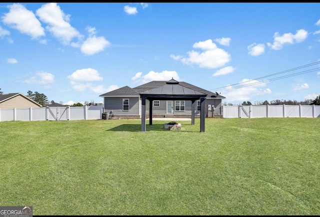 exterior space featuring a gazebo, a lawn, a fenced backyard, and a gate