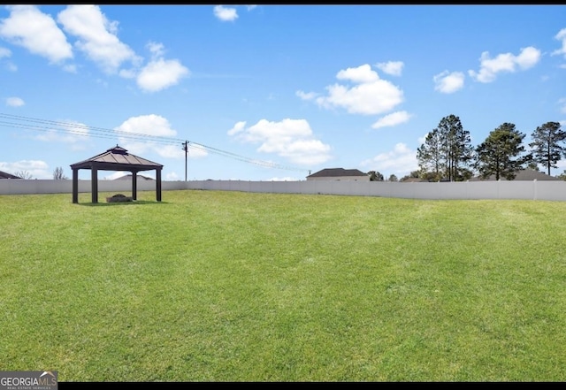 view of yard with fence and a gazebo