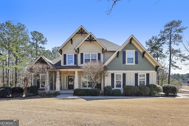 craftsman house with a front lawn and board and batten siding