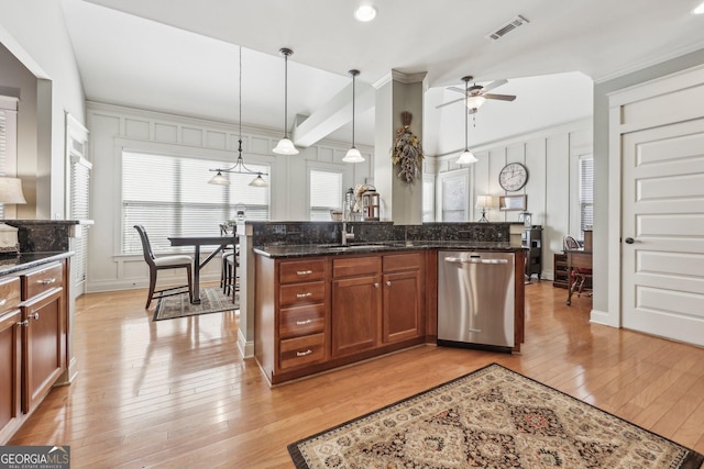 kitchen featuring pendant lighting, visible vents, light wood-style flooring, and stainless steel dishwasher