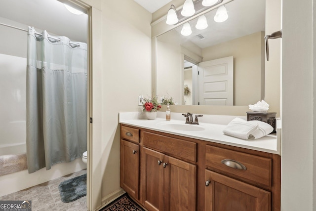 bathroom with curtained shower, vanity, and toilet