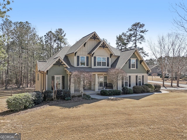 craftsman-style home featuring board and batten siding, a porch, and a front lawn