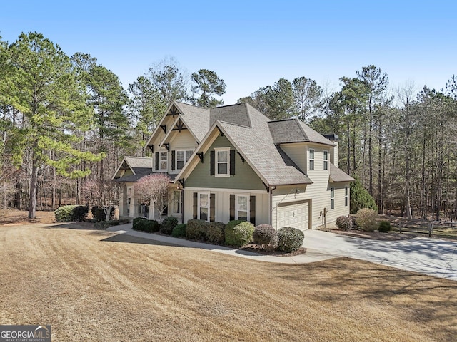 craftsman-style home featuring driveway, a garage, and a front yard