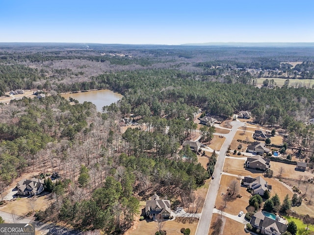 bird's eye view with a forest view and a water view