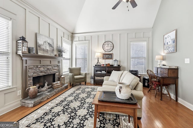 living room with a fireplace, plenty of natural light, and wood finished floors