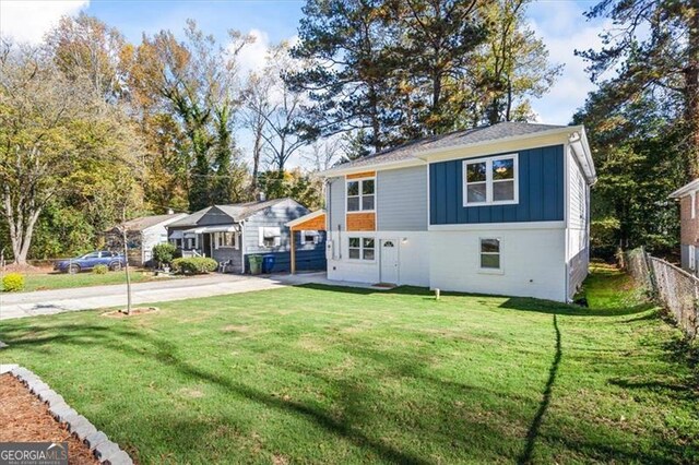 1270 Graymont Dr, Atlanta, GA 30310 - view of front facade with fence, a front lawn, board and batten siding, and concrete driveway