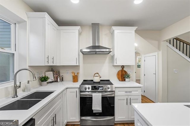 1270 Graymont Dr, Atlanta, GA 30310 - kitchen with wall chimney exhaust hood, stainless steel electric stove, a sink, and white cabinets