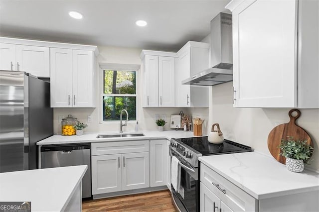 1270 Graymont Dr, Atlanta, GA 30310 - kitchen with light countertops, a sink, appliances with stainless steel finishes, wall chimney range hood, and white cabinets