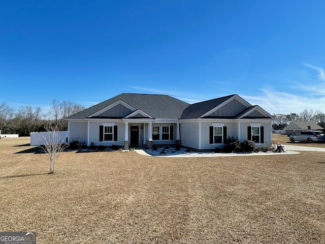 view of front facade featuring board and batten siding and fence