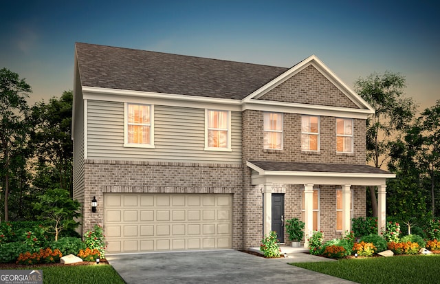 view of front of house with aphalt driveway, a garage, and brick siding