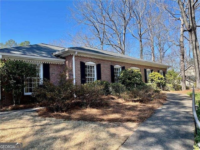 view of side of home featuring brick siding