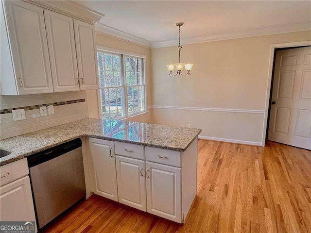 kitchen with crown molding, light wood finished floors, stainless steel dishwasher, white cabinets, and a peninsula