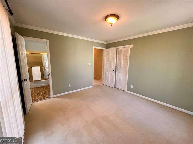 unfurnished bedroom with carpet floors, a closet, crown molding, and baseboards