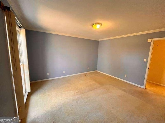 unfurnished room featuring crown molding, light colored carpet, and baseboards