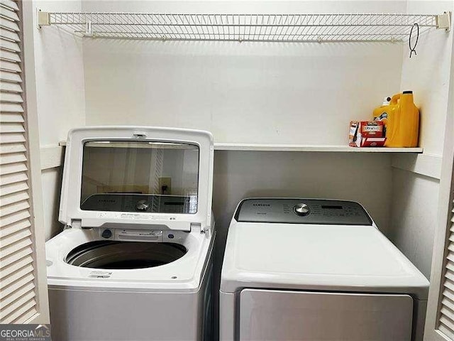 washroom with laundry area and washer and dryer