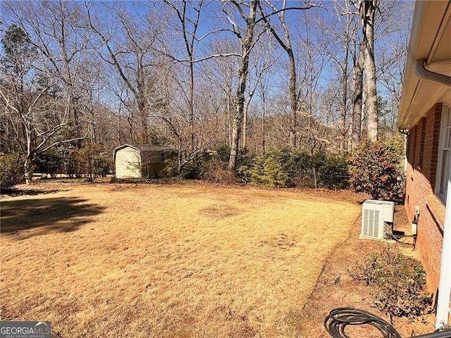 view of yard with a storage shed and an outbuilding