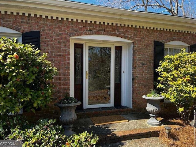 property entrance with brick siding