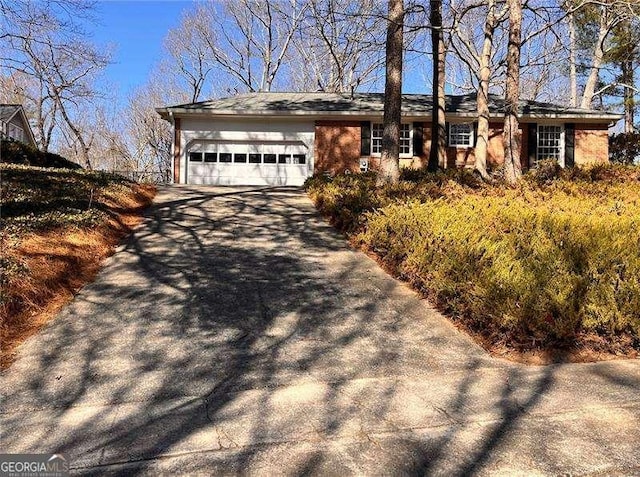 view of side of home with aphalt driveway and an attached garage