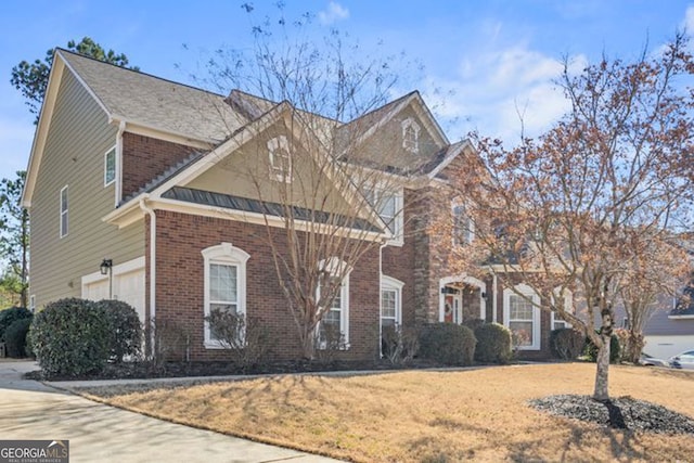 view of front of property with brick siding and a front yard