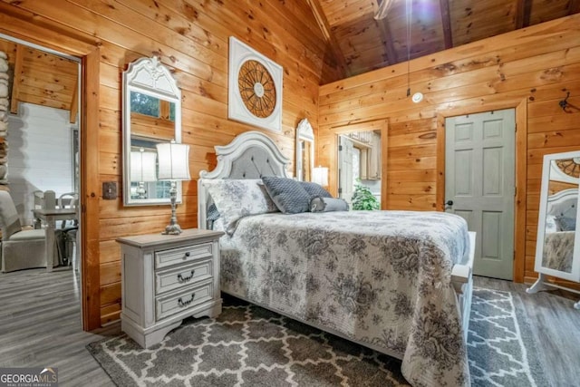 bedroom with lofted ceiling, wood finished floors, wood ceiling, and wooden walls