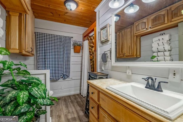 bathroom with wood ceiling, wood finished floors, and vanity