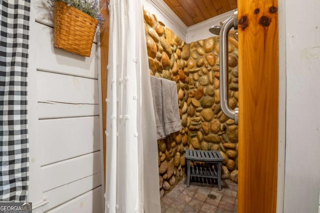 bathroom featuring ornamental molding, rustic walls, and wooden ceiling