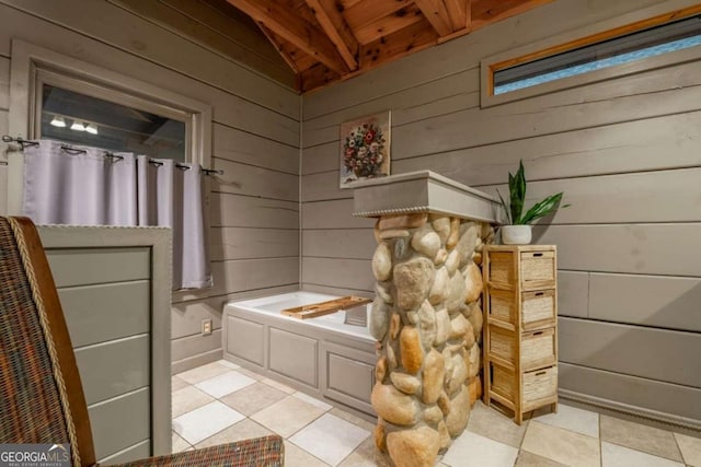 full bathroom with a garden tub, wood ceiling, vaulted ceiling, wooden walls, and tile patterned flooring