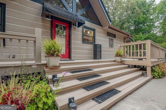 view of exterior entry featuring a deck