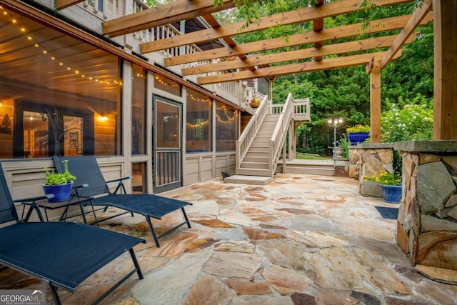 view of patio / terrace with stairs and a pergola