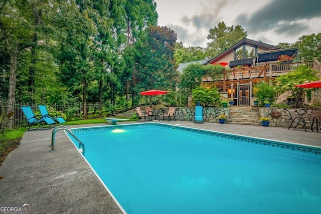 view of pool featuring a patio, fence, and a fenced in pool