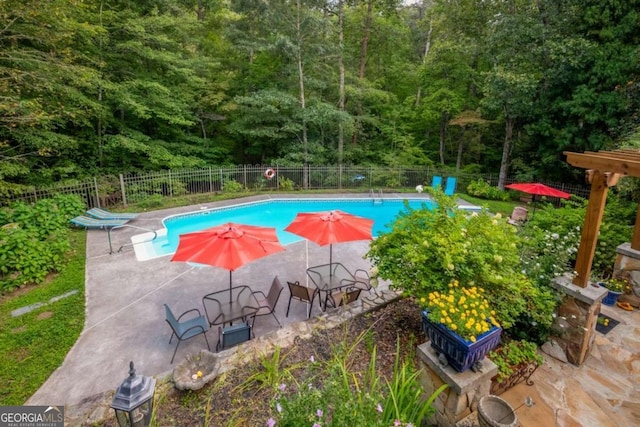 view of pool with a patio area, fence, and a fenced in pool