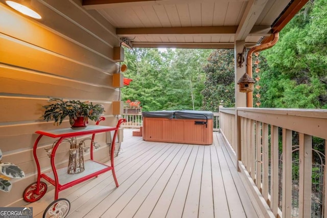 wooden deck with a hot tub