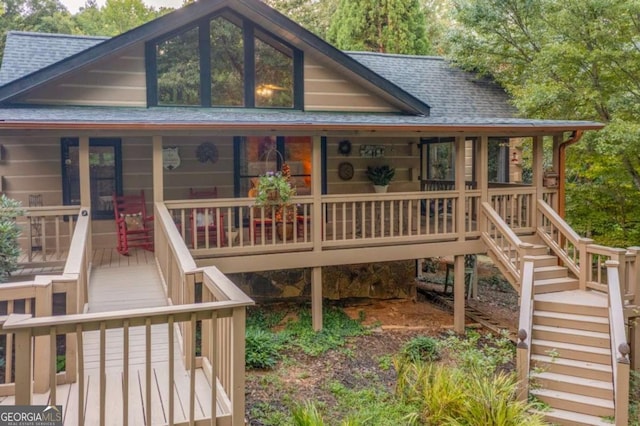 view of front of property with stairs and a shingled roof