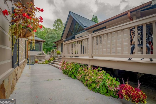 view of side of home with a shingled roof