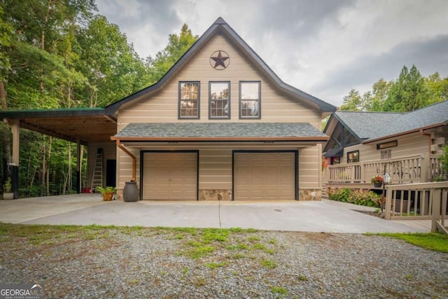 view of front of property with driveway and a shingled roof