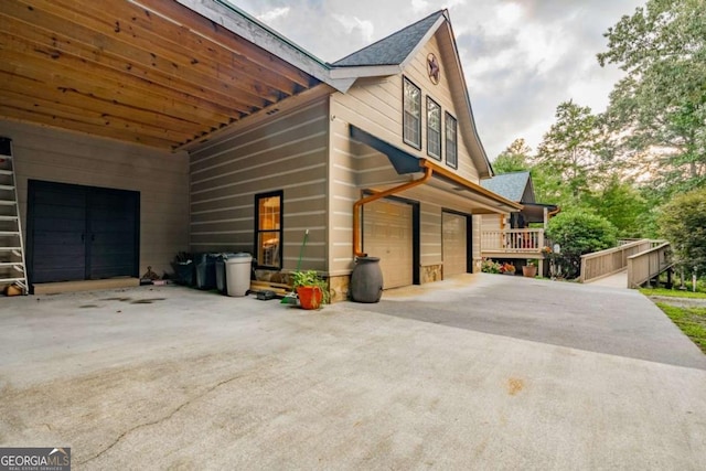 view of property exterior with a garage and driveway