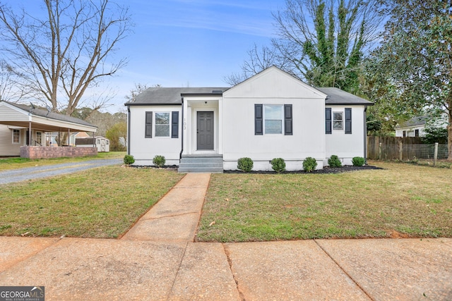 bungalow-style house with a front yard and fence