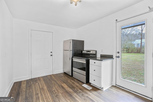 kitchen with visible vents, dark countertops, appliances with stainless steel finishes, dark wood-type flooring, and white cabinetry