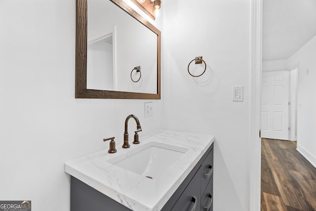 bathroom featuring wood finished floors and vanity