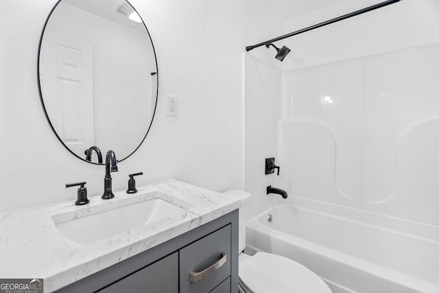 full bath featuring toilet, bathtub / shower combination, and vanity