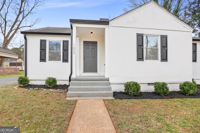 view of front of property with roof with shingles, a front lawn, and crawl space