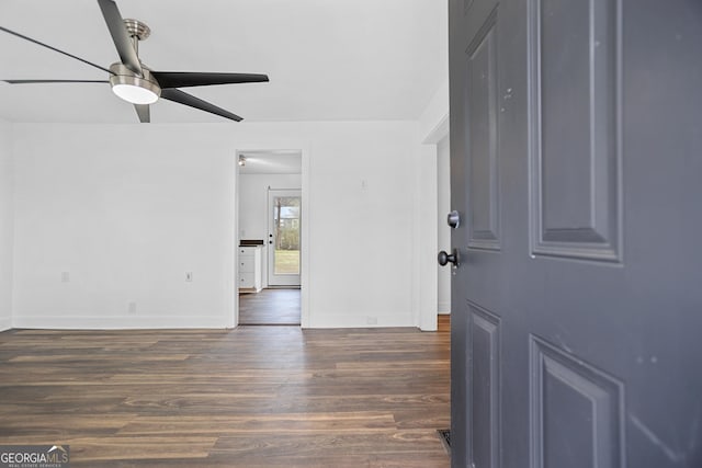 spare room with ceiling fan, baseboards, and wood finished floors