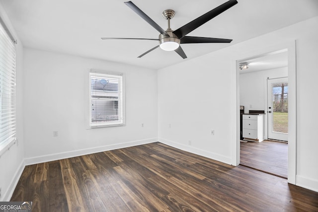 empty room with ceiling fan, baseboards, and wood finished floors