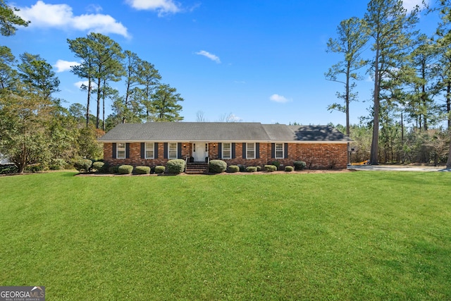 single story home featuring brick siding and a front yard