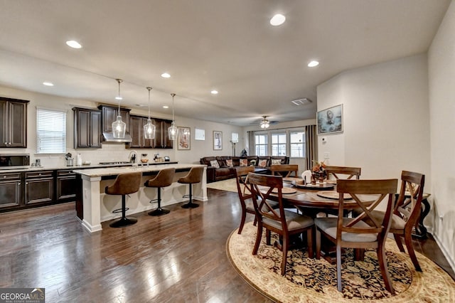 dining area featuring recessed lighting, visible vents, plenty of natural light, and dark wood-type flooring