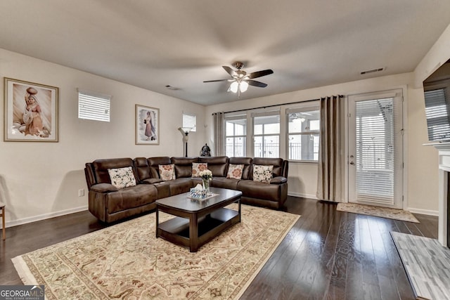 living area with baseboards, ceiling fan, visible vents, and a wealth of natural light