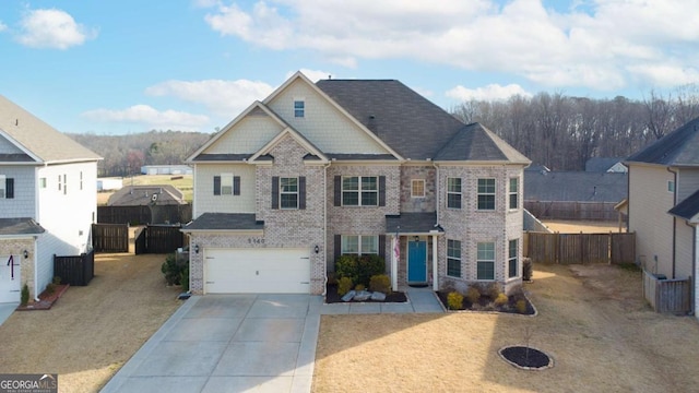 view of front facade with brick siding, a shingled roof, fence, concrete driveway, and an attached garage