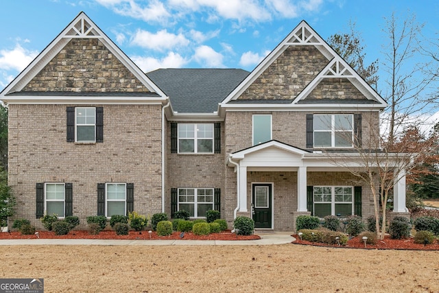 craftsman house with brick siding and a porch