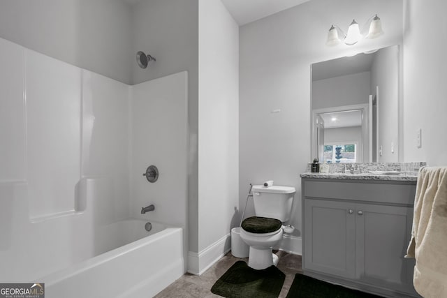 bathroom featuring toilet, vanity, shower / tub combination, baseboards, and tile patterned floors
